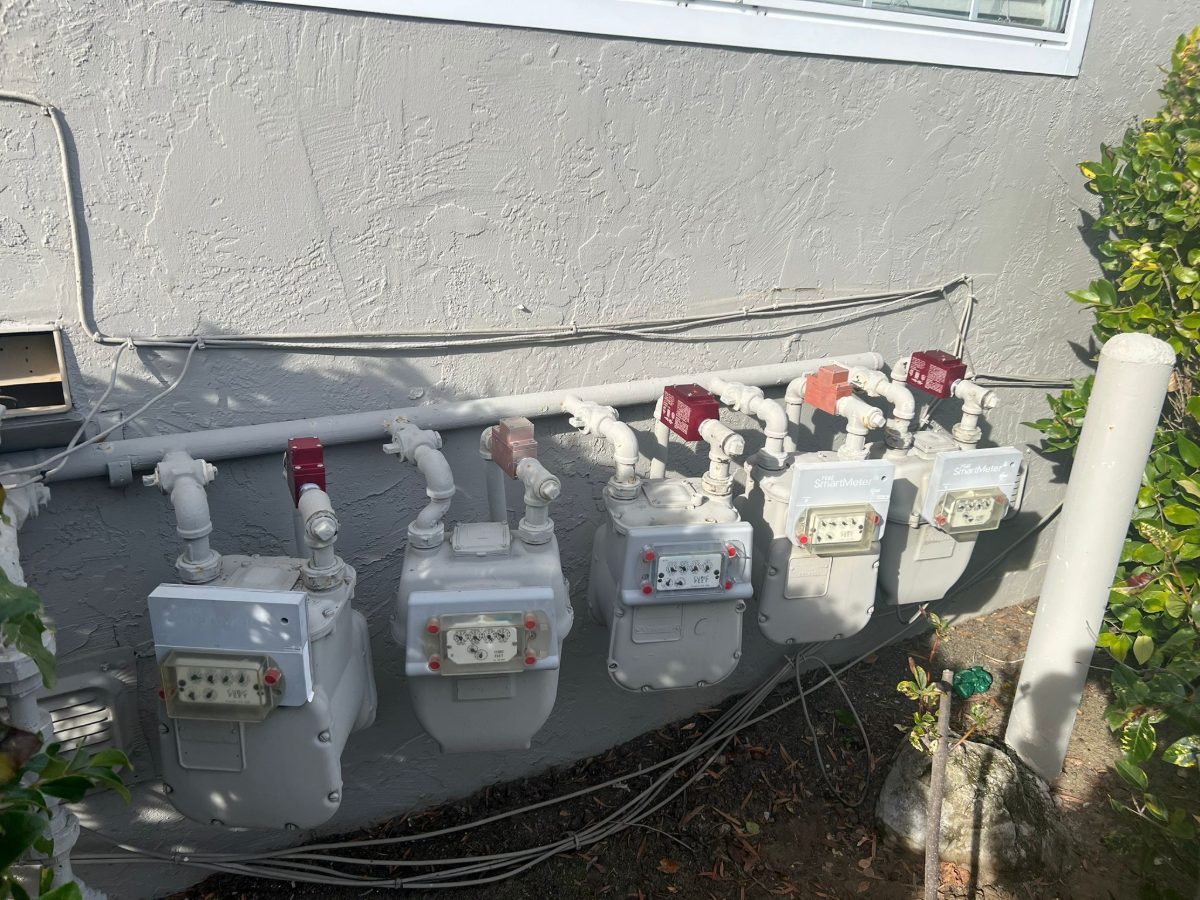 Gas meters and shut-off valves on the side of a home