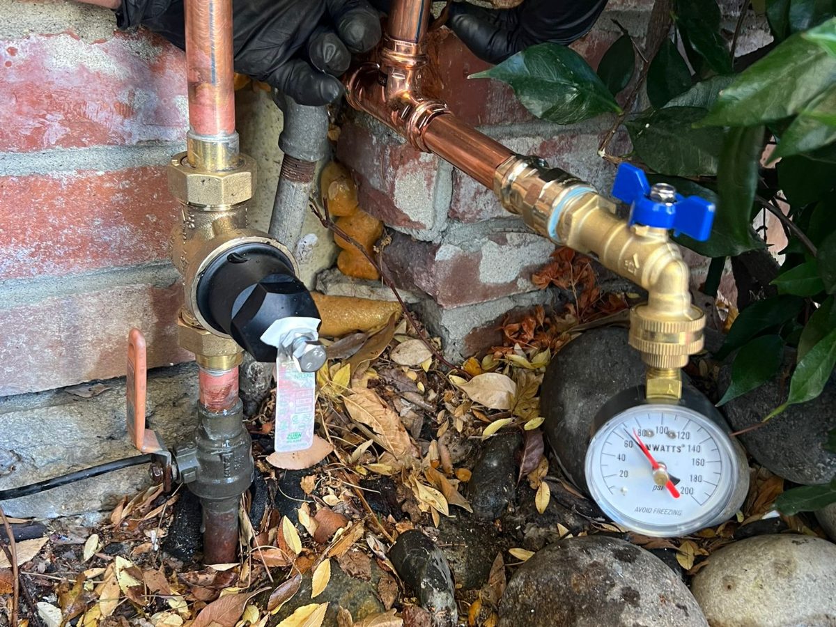 Leaking underground water line exposed and repaired with new valves and a pressure gauge