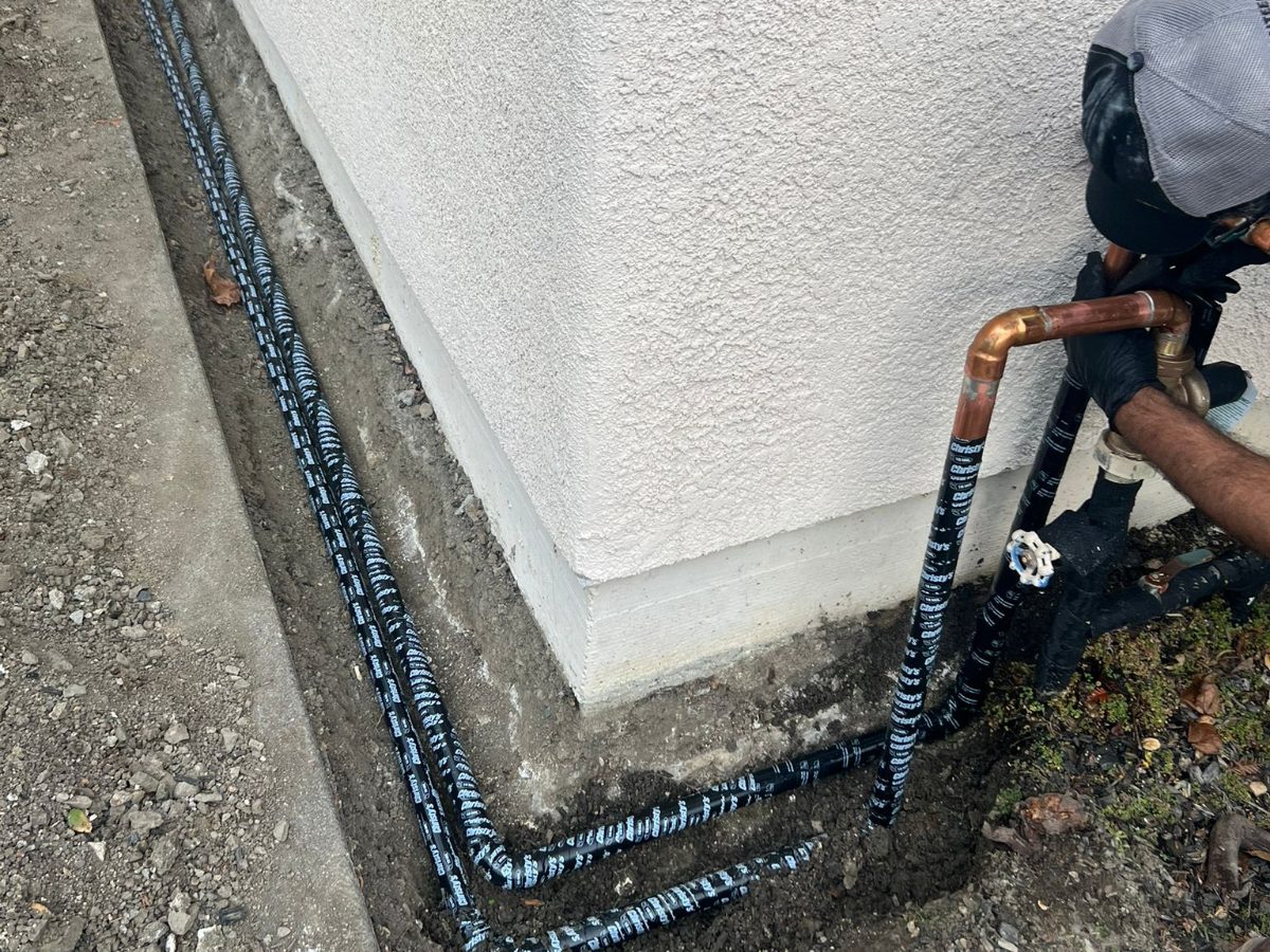 New sewer drain line run along a home foundation