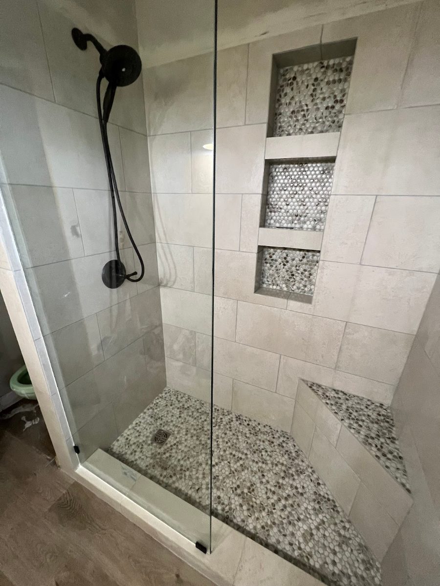 Finished tiled walk-in shower with black fixtures