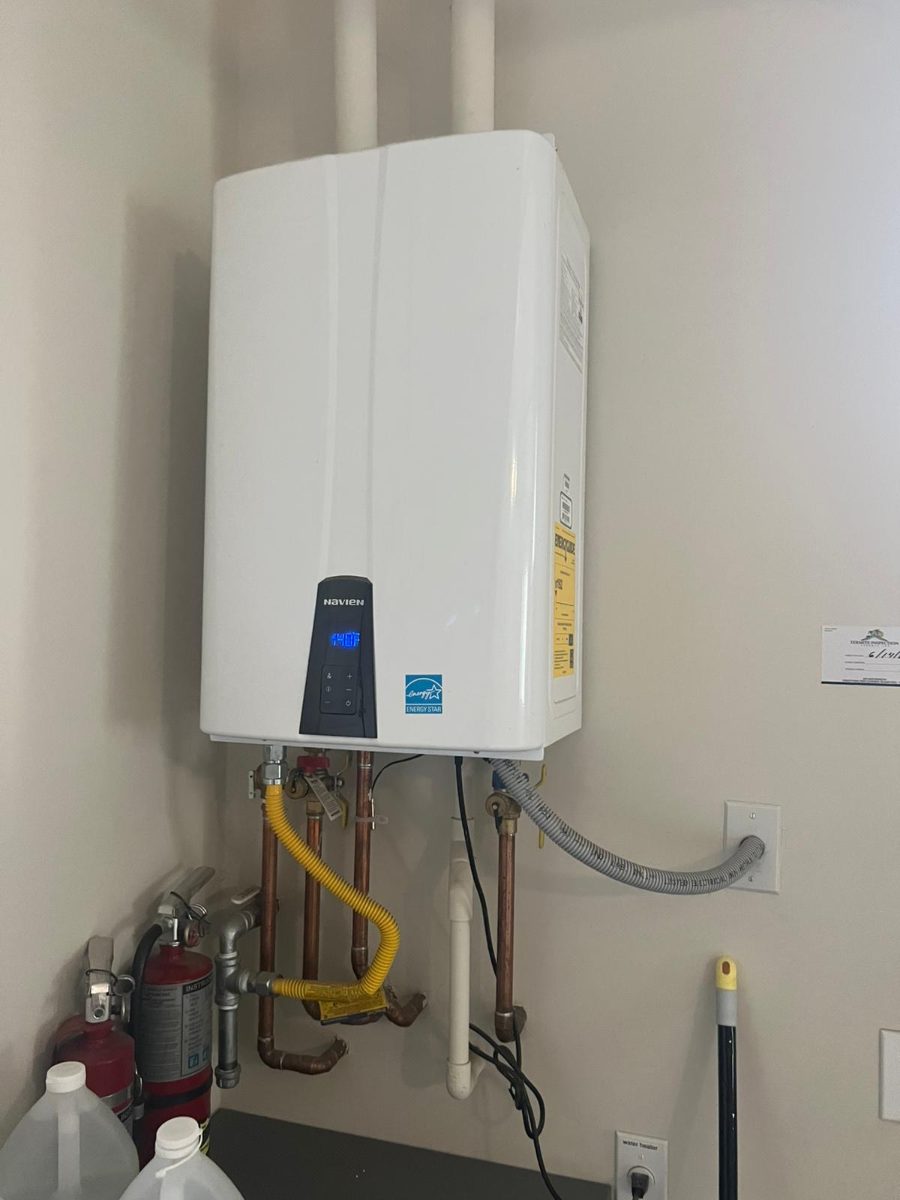 Navien tankless water heater installed on a wall with new copper and gas connections