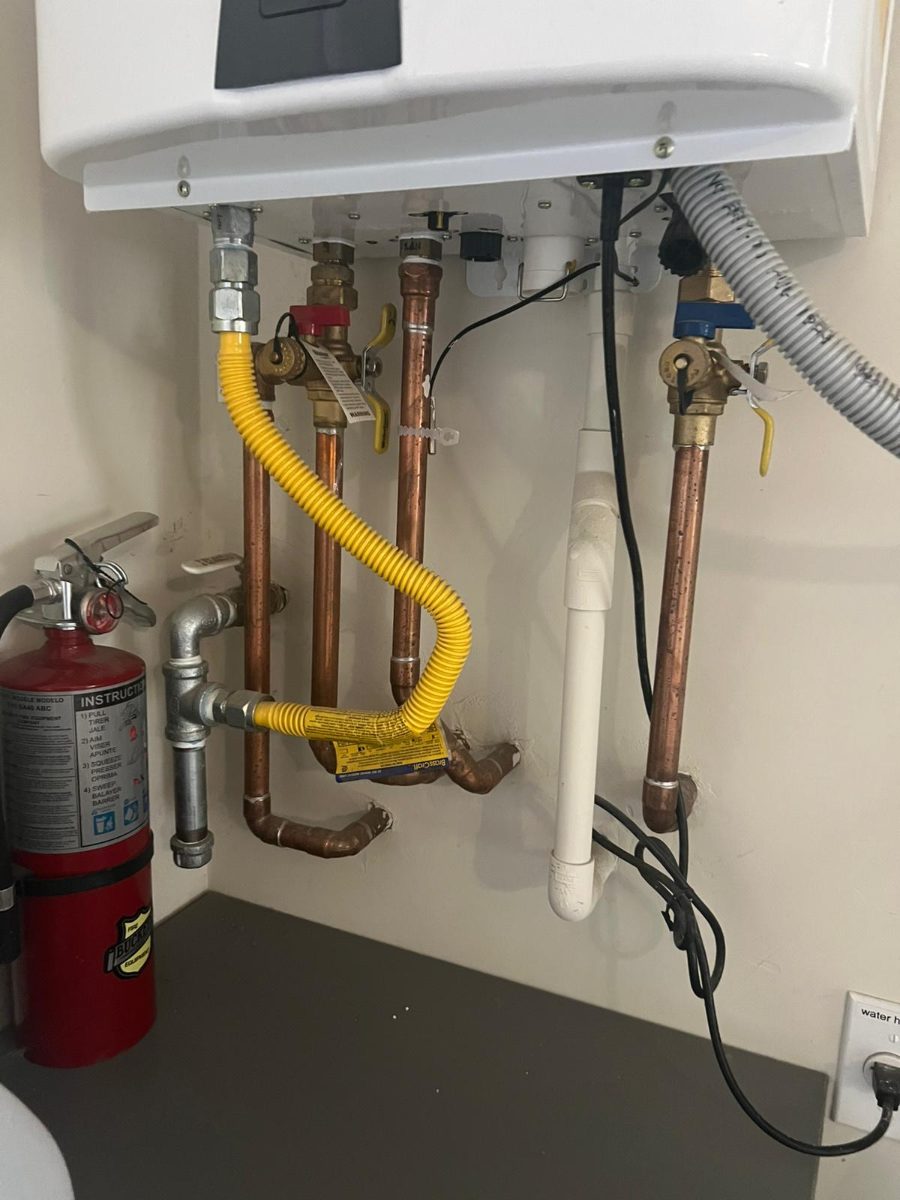 Newly installed water heater with clean copper connections and a gas line